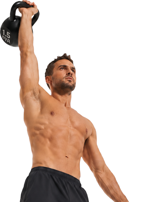Athlete holding a kettlebell overhead in a dark training space